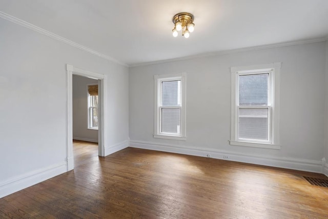 612 E Mitchell St, Petoskey, MI 49770 - unfurnished room featuring baseboards, wood finished floors, and ornamental molding