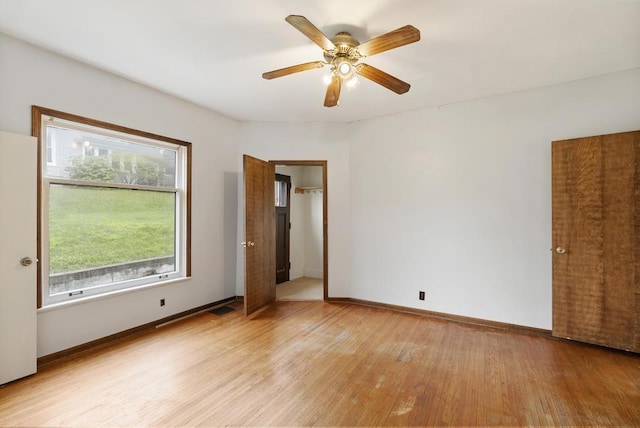 612 E Mitchell St, Petoskey, MI 49770 - unfurnished room with light wood-style flooring, ceiling fan, and baseboards