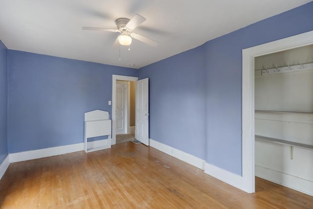 612 E Mitchell St, Petoskey, MI 49770 - unfurnished bedroom featuring wood finished floors, baseboards, a closet, and a ceiling fan