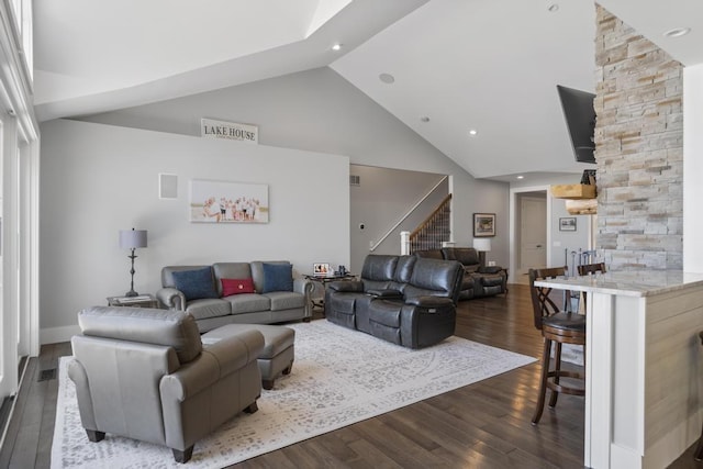 4435 Lake Shore Dr, Charlevoix, MI 49720 - living room with high vaulted ceiling, dark wood-style floors, stairs, and recessed lighting