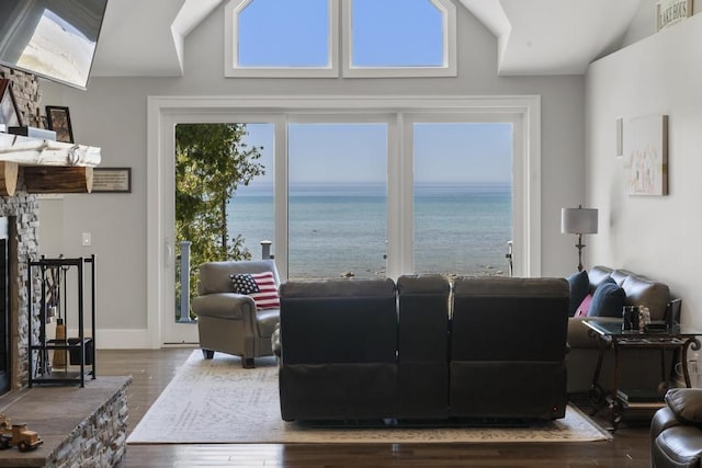 4435 Lake Shore Dr, Charlevoix, MI 49720 - living room with wood finished floors, a water view, and a fireplace