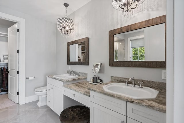 4435 Lake Shore Dr, Charlevoix, MI 49720 - bathroom with a chandelier, a spacious closet, toilet, and double vanity