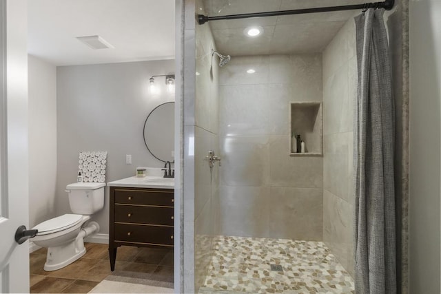 4435 Lake Shore Dr, Charlevoix, MI 49720 - bathroom featuring a tile shower, toilet, vanity, tile patterned flooring, and recessed lighting