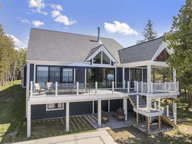 4435 Lake Shore Dr, Charlevoix, MI 49720 - back of property featuring stairs, roof with shingles, a patio area, and a deck