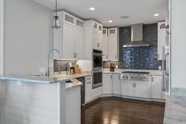 4435 Lake Shore Dr, Charlevoix, MI 49720 - kitchen with appliances with stainless steel finishes, wall chimney range hood, a peninsula, white cabinetry, and glass insert cabinets