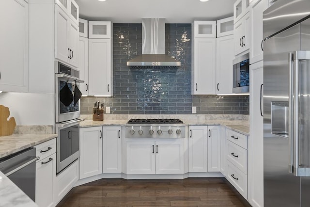 4435 Lake Shore Dr, Charlevoix, MI 49720 - kitchen featuring stainless steel appliances, wall chimney range hood, white cabinets, decorative backsplash, and dark wood-type flooring