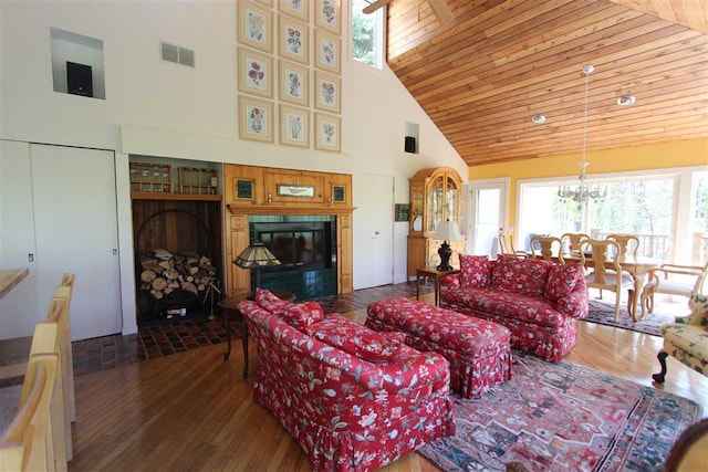 3237 Greenbriar, Harbor Springs, MI 49740 - living area featuring high vaulted ceiling, a fireplace, hardwood / wood-style floors, plenty of natural light, and a chandelier