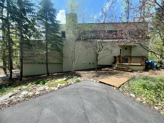 3237 Greenbriar, Harbor Springs, MI 49740 - back of house featuring a chimney and a wooden deck
