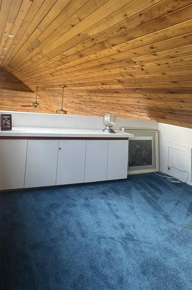 3237 Greenbriar, Harbor Springs, MI 49740 - bonus room featuring dark carpet, wood ceiling, vaulted ceiling, and wood walls