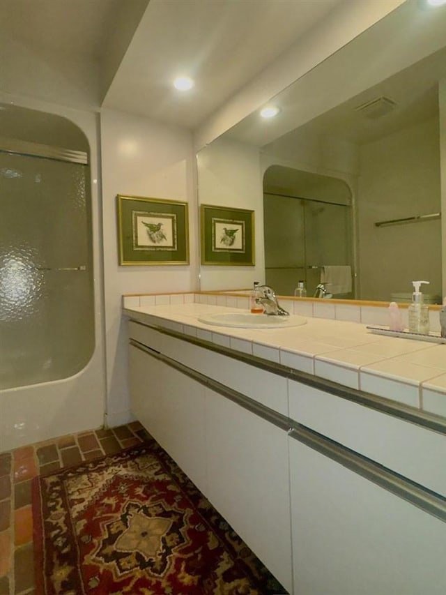 3237 Greenbriar, Harbor Springs, MI 49740 - full bathroom featuring vanity, recessed lighting, brick patterned flooring, and washtub / shower combination