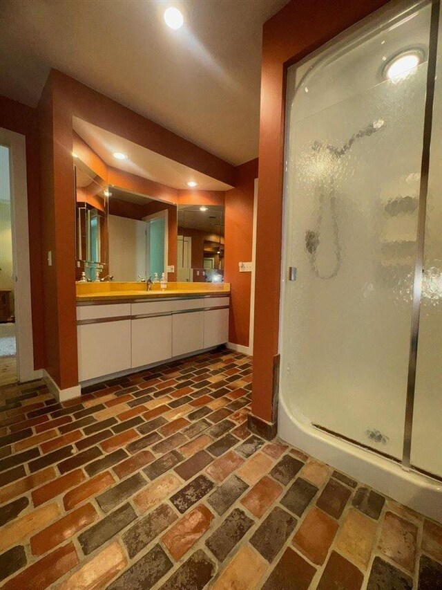 3237 Greenbriar, Harbor Springs, MI 49740 - full bath with baseboards, brick floors, a stall shower, recessed lighting, and vanity
