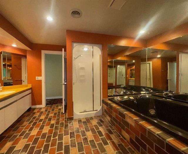 3237 Greenbriar, Harbor Springs, MI 49740 - full bathroom with brick patterned flooring, a jetted tub, baseboards, a stall shower, and vanity