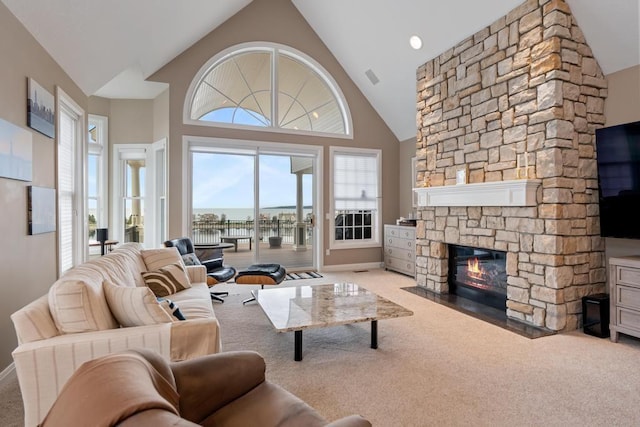 4104 Harborview Rdg Unit 28, Bay Harbor, MI 49770 - living room featuring carpet, a stone fireplace, high vaulted ceiling, and baseboards