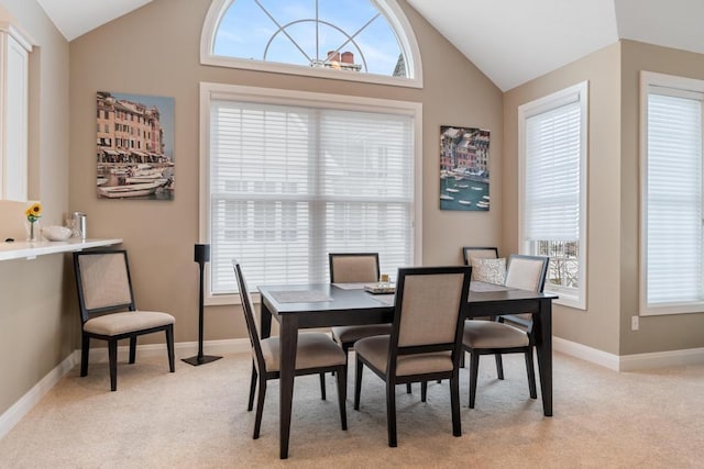4104 Harborview Rdg Unit 28, Bay Harbor, MI 49770 - dining area featuring lofted ceiling, light carpet, and baseboards