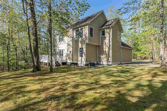 1766 Chippewa Bch, Indian River, MI 49749 - view of side of home with a yard and a wooden deck