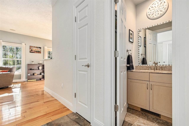 1766 Chippewa Bch, Indian River, MI 49749 - hallway with light wood-style floors and a textured ceiling