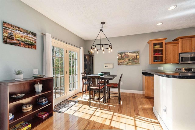 1766 Chippewa Bch, Indian River, MI 49749 - dining area featuring light wood finished floors, a textured ceiling, a chandelier, and recessed lighting