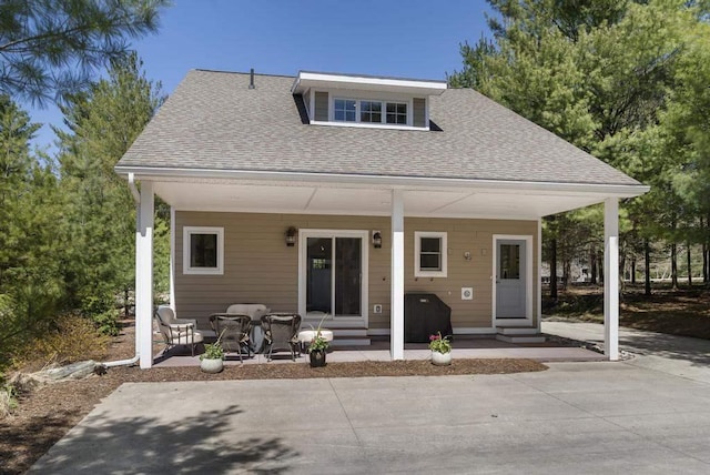 04264 N Concorde, Boyne City, MI 49712 - bungalow-style home with a shingled roof and entry steps