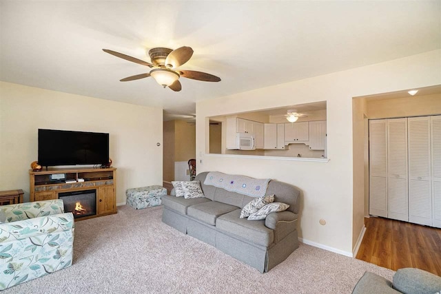 806 Arlington Unit 11, Petoskey, MI 49770 - carpeted living area featuring ceiling fan and baseboards