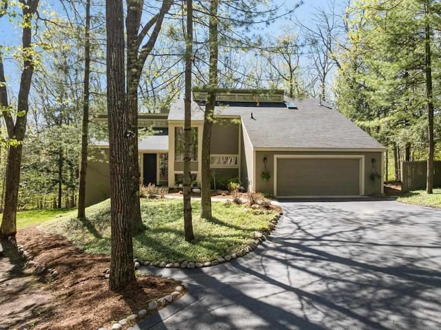 2018 Greenbriar Ter, Harbor Springs, MI 49740 - mid-century inspired home featuring concrete driveway, an attached garage, and stucco siding
