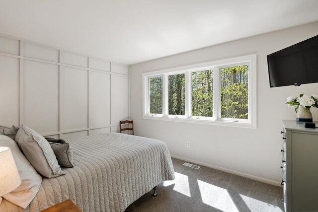 2018 Greenbriar Ter, Harbor Springs, MI 49740 - bedroom featuring multiple windows, carpet flooring, and baseboards