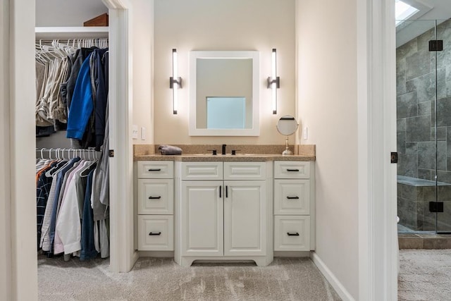 2018 Greenbriar Ter, Harbor Springs, MI 49740 - bathroom with a stall shower, vanity, a spacious closet, and baseboards