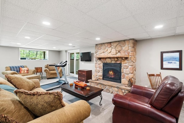 2018 Greenbriar Ter, Harbor Springs, MI 49740 - carpeted living room featuring a drop ceiling, healthy amount of natural light, and a fireplace