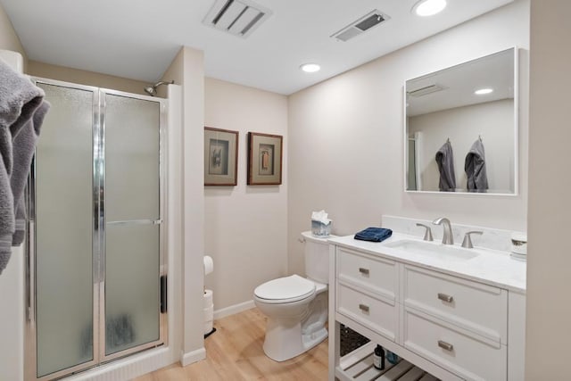2018 Greenbriar Ter, Harbor Springs, MI 49740 - full bathroom with a shower stall, wood finished floors, toilet, vanity, and recessed lighting