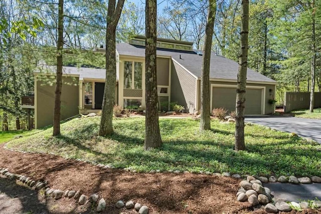 2018 Greenbriar Ter, Harbor Springs, MI 49740 - view of front of property featuring a garage and asphalt driveway