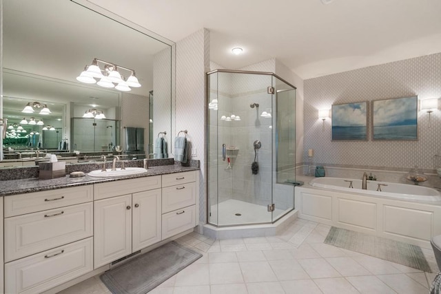 4064 Harborview Rdg Unit 17, Bay Harbor, MI 49770 - bathroom with tile patterned floors, a shower stall, vanity, and a garden tub