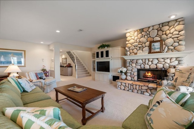4064 Harborview Rdg Unit 17, Bay Harbor, MI 49770 - living room featuring a fireplace, light carpet, recessed lighting, decorative columns, and stairway