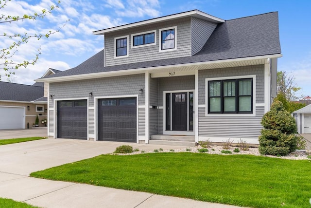 917 Grove St, Petoskey, MI 49770 - view of front of property featuring driveway, a front lawn, a shingled roof, and an attached garage
