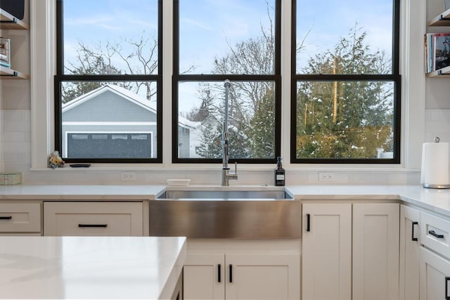 917 Grove St, Petoskey, MI 49770 - kitchen with white cabinets, light countertops, and a sink
