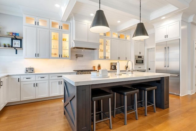 917 Grove St, Petoskey, MI 49770 - kitchen with appliances with stainless steel finishes, a sink, white cabinets, backsplash, and beam ceiling