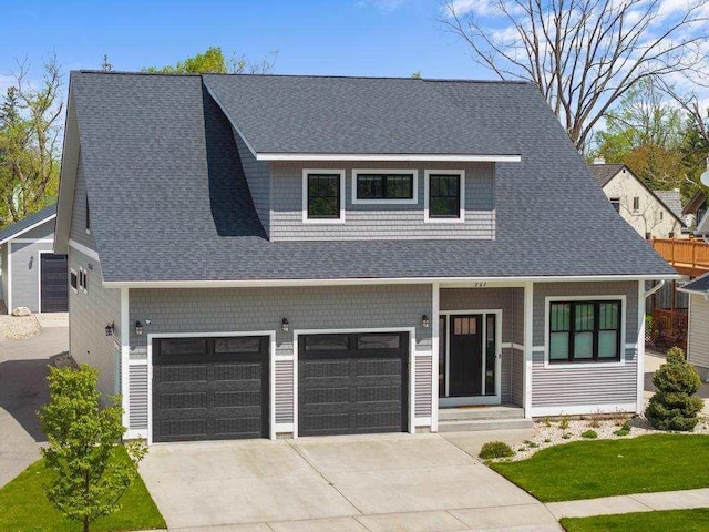 917 Grove St, Petoskey, MI 49770 - view of front facade featuring an attached garage, driveway, and a shingled roof