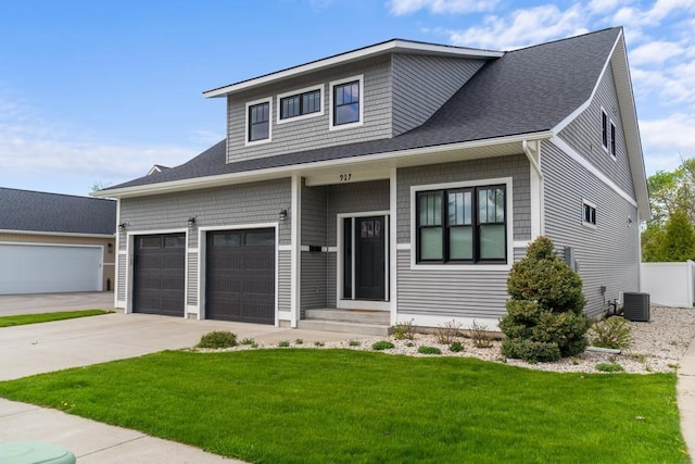 917 Grove St, Petoskey, MI 49770 - view of front of property featuring concrete driveway, a front lawn, central AC, a shingled roof, and entry steps