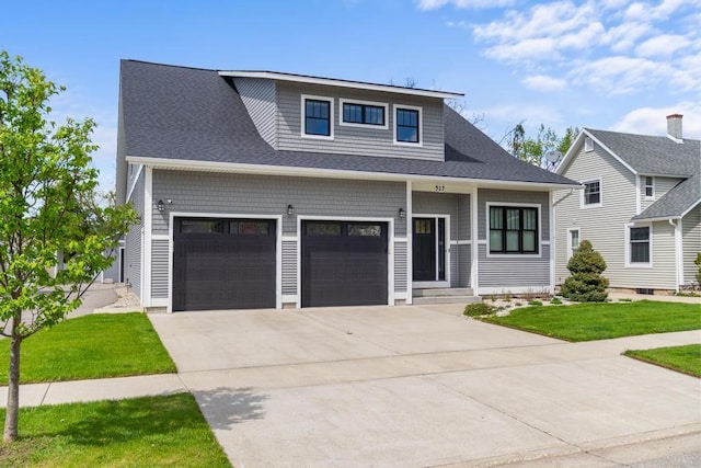 917 Grove St, Petoskey, MI 49770 - view of front facade with driveway, a front yard, an attached garage, and roof with shingles