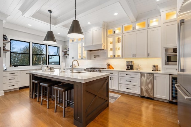 917 Grove St, Petoskey, MI 49770 - kitchen featuring a sink, wine cooler, wood finished floors, decorative backsplash, and recessed lighting