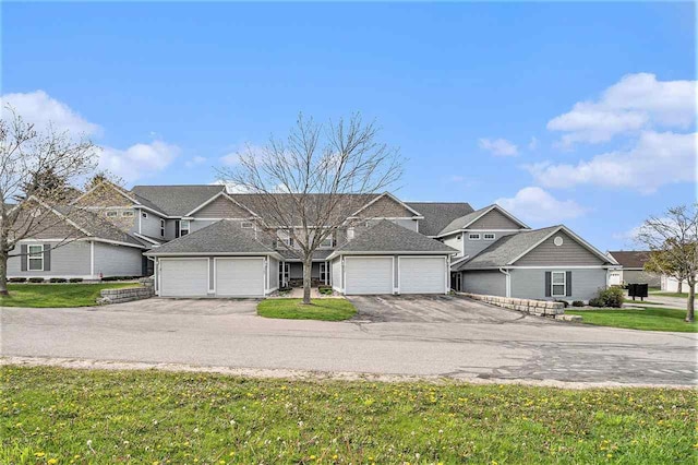 1556 Emerald Ct Unit 89, Petoskey, MI 49770 - view of front of home with an attached garage, asphalt driveway, a front yard, and a residential view