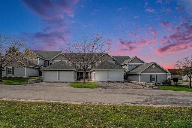 1556 Emerald Ct Unit 89, Petoskey, MI 49770 - view of front of home featuring an attached garage, asphalt driveway, and a lawn