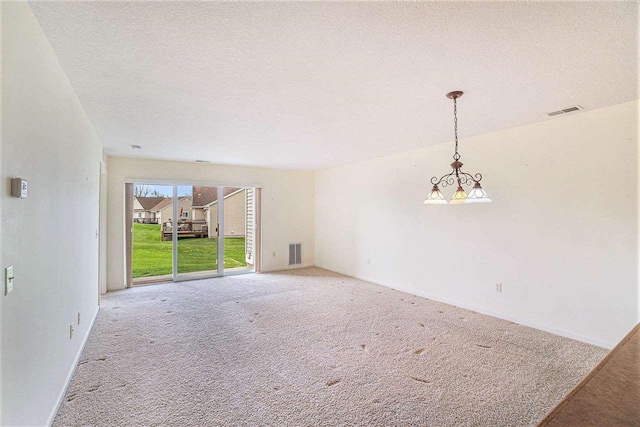 1556 Emerald Ct Unit 89, Petoskey, MI 49770 - unfurnished living room featuring carpet flooring, a textured ceiling, and baseboards