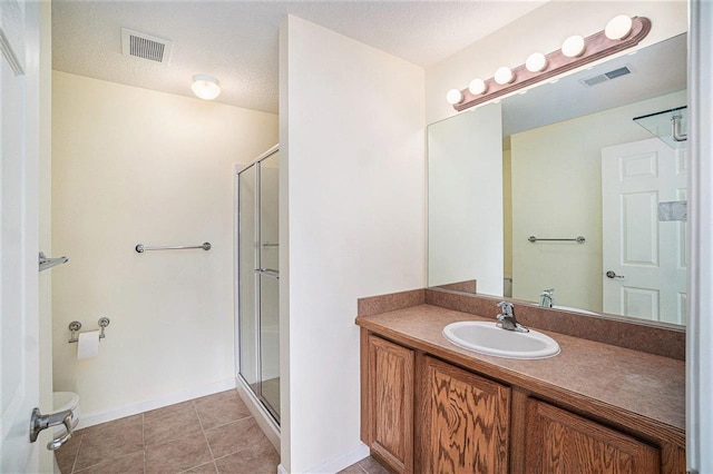 1556 Emerald Ct Unit 89, Petoskey, MI 49770 - bathroom with vanity, a shower stall, tile patterned flooring, and toilet
