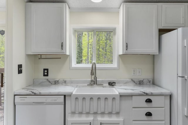 7245-83 Upper Kelsey Dr, Charlevoix, MI 49720 - kitchen featuring white appliances, a sink, white cabinetry, and light stone countertops