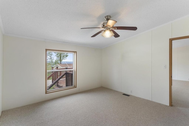 7245-83 Upper Kelsey Dr, Charlevoix, MI 49720 - carpeted empty room with ceiling fan, a textured ceiling, and ornamental molding
