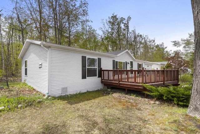 7245-83 Upper Kelsey Dr, Charlevoix, MI 49720 - back of property with a deck