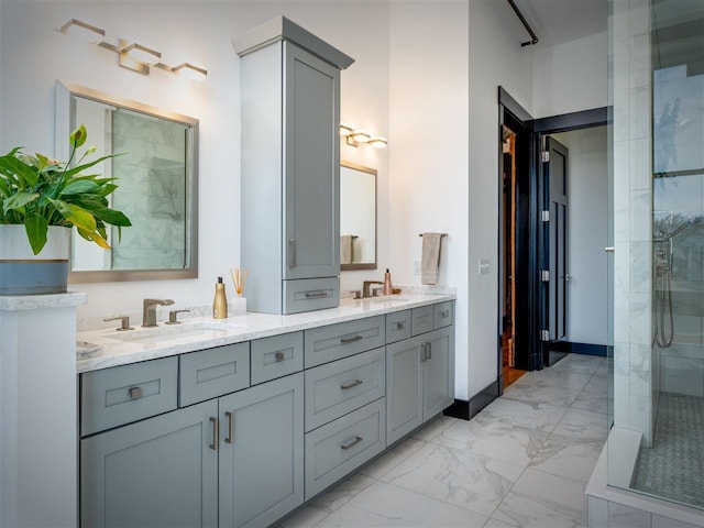 422 E Mitchell Unit 1, Petoskey, MI 49770 - bathroom with marble finish flooring, double vanity, and tiled shower