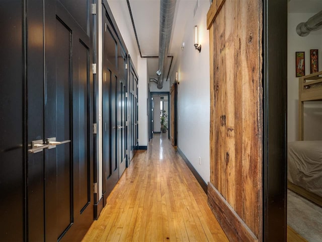 422 E Mitchell Unit 1, Petoskey, MI 49770 - hall featuring light wood-style floors and baseboards