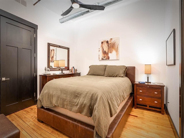 422 E Mitchell Unit 1, Petoskey, MI 49770 - bedroom with light wood-style floors, a high ceiling, and a ceiling fan