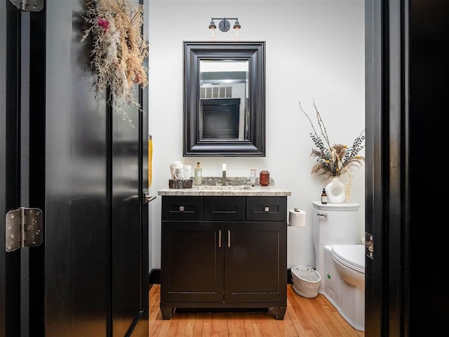 422 E Mitchell Unit 1, Petoskey, MI 49770 - bathroom featuring wood finished floors, toilet, and vanity