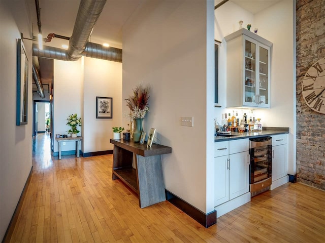422 E Mitchell Unit 1, Petoskey, MI 49770 - indoor dry bar featuring beverage cooler and light wood finished floors
